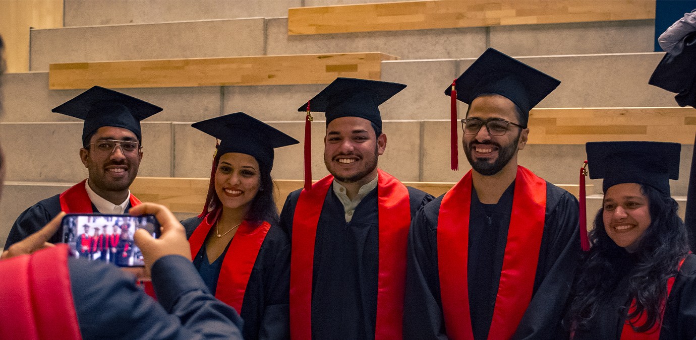 a group of people wearing graduation gowns and caps