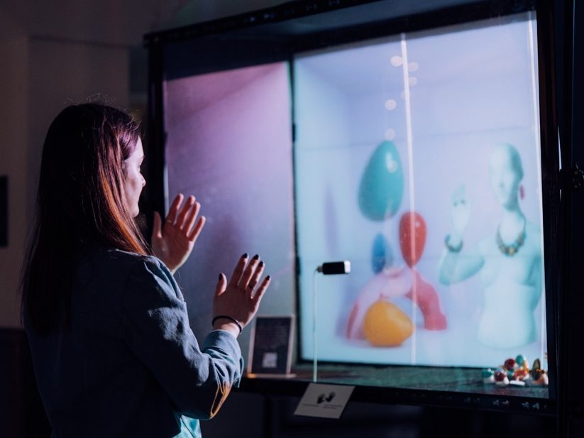 Woman interacting with digital art installation