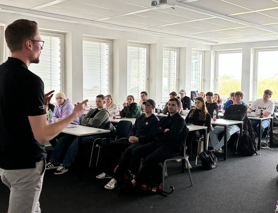 man teaching class with concentrated students