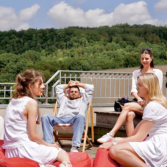 a group of people sitting on a deck